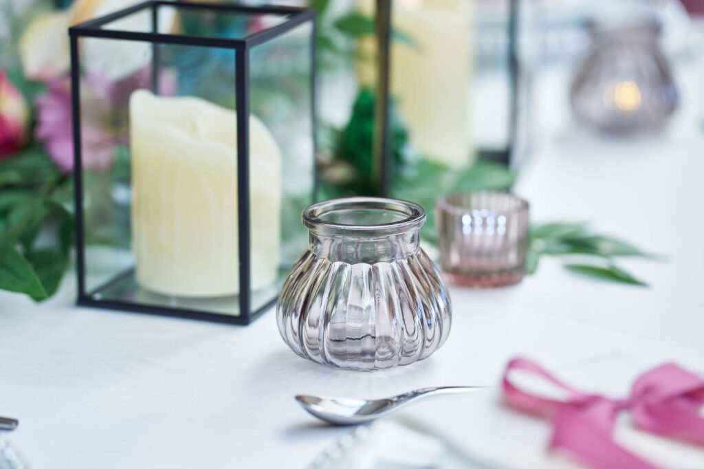 Rustic marriage table styling with lantern decor and tealight holders.