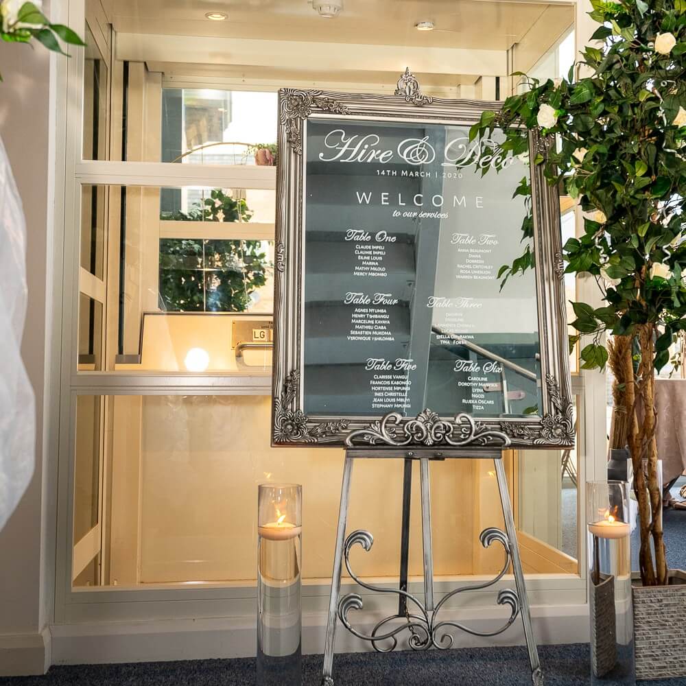 Elegant acrylic welcome signage for wedding with Mr & Mrs design, styled on a vintage easel.