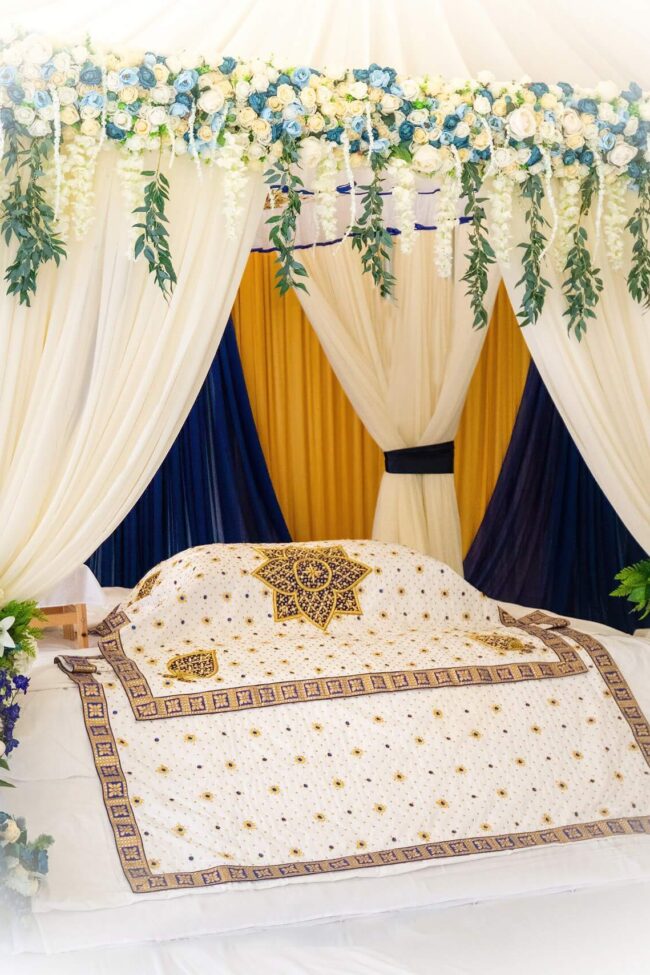 Canopy backdrop hire with white draping and blue and gold styling