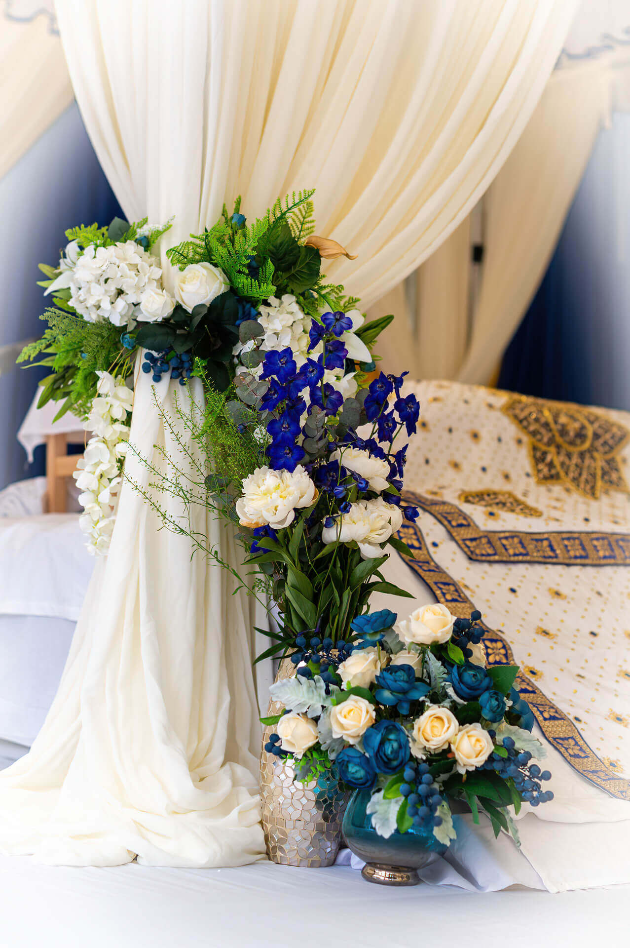 White canopy draping with blue and white floral details