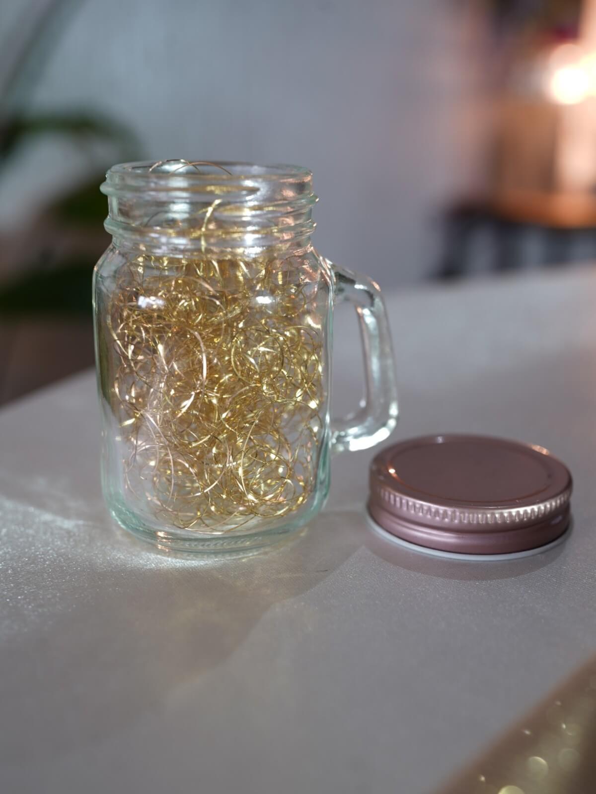 Glass mason jar with handle, decorative lights and separate screw-top lid
