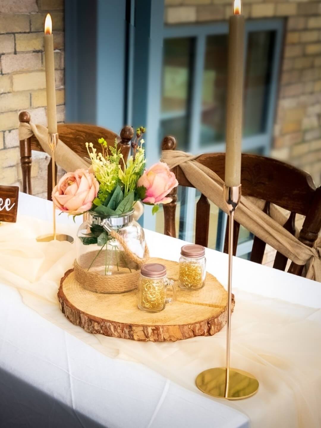 Small mason jars with lids used in a wedding table decoration display