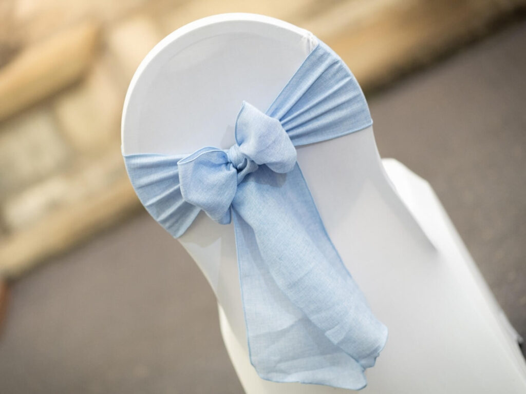 Baby blue chair sash for hire tied in a soft bow