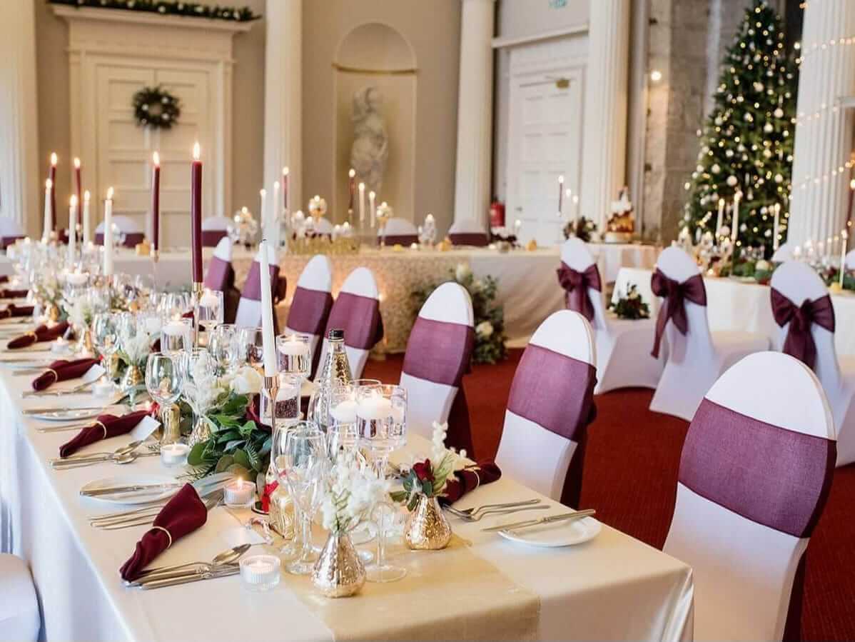 Red chair sashes styled across guest chairs for a coordinated event seating look