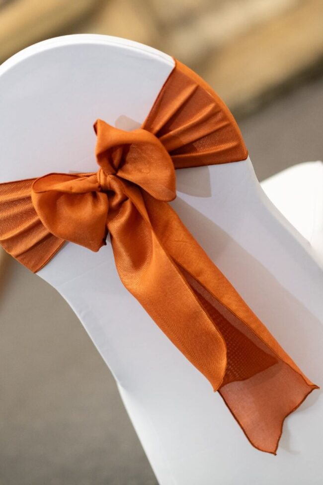 Terracotta chair sash for hire tied in a full bow