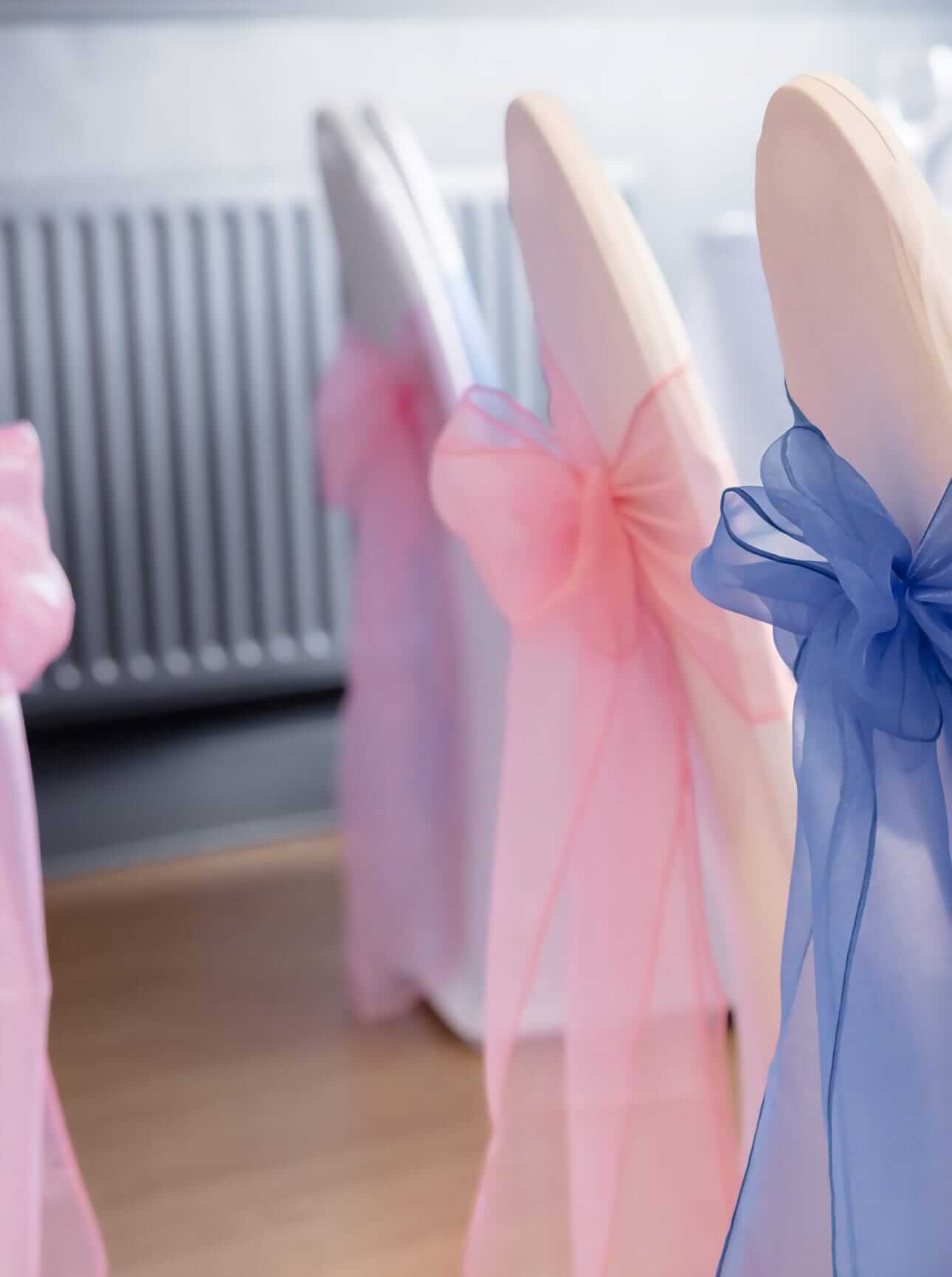 Raspberry pink chair sashes with blue sash styling nearby