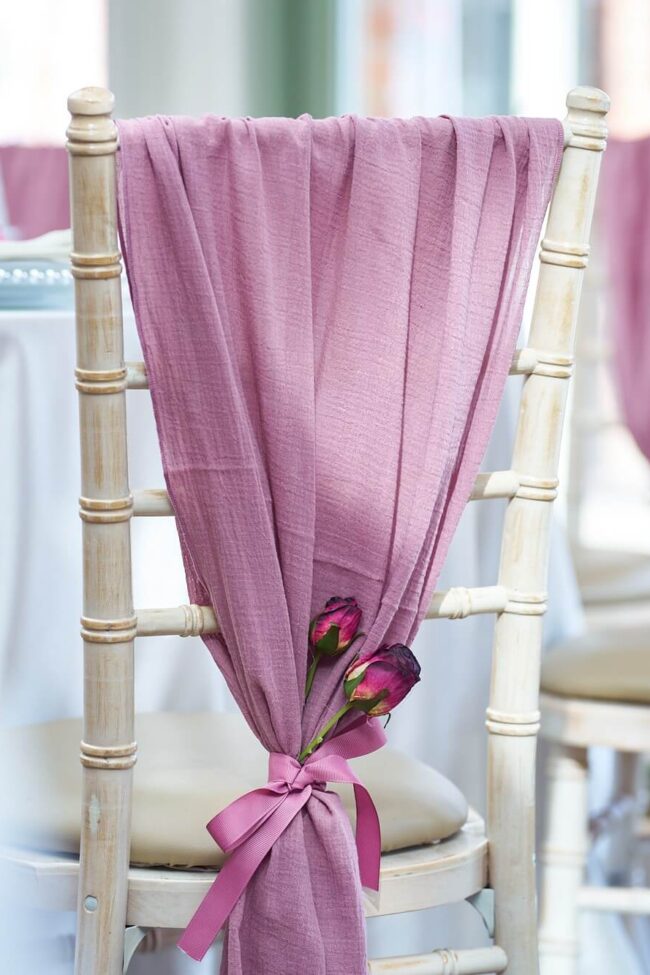 blush pink drape for chairs in cheesecloth on a chiavari chair