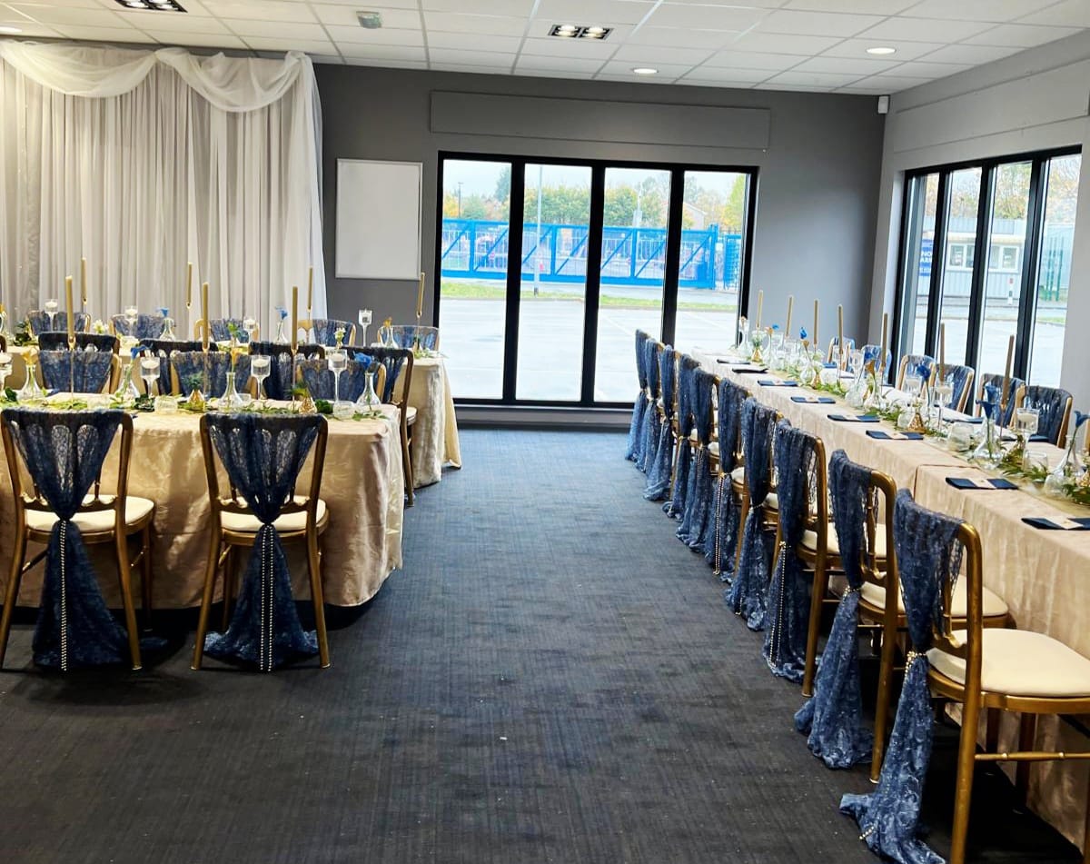 Navy lace chair drapes styled across a formal reception room