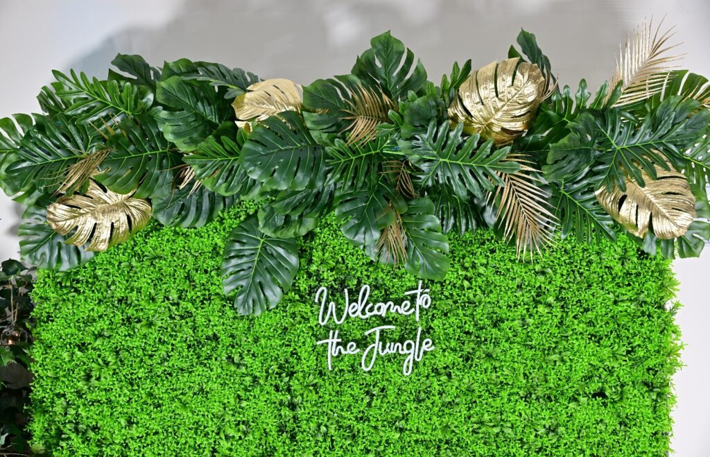 Foliage wall styled with tropical leaves and gold accents