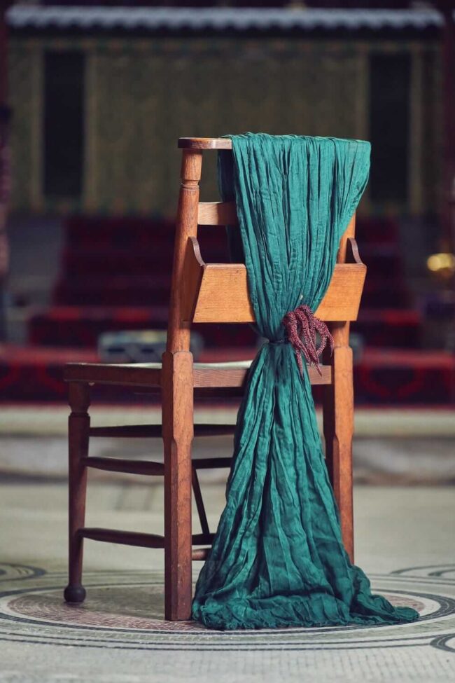 Green chair drape for hire styled in a long textured drop