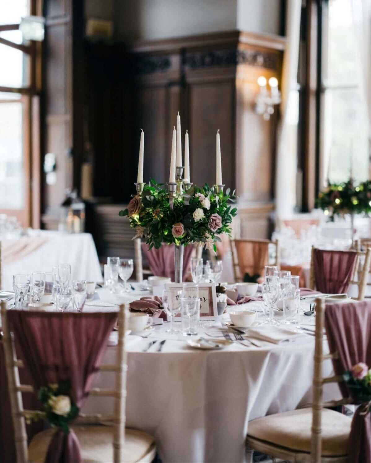 Mauve drape styling on chiavari chairs around a wedding reception table