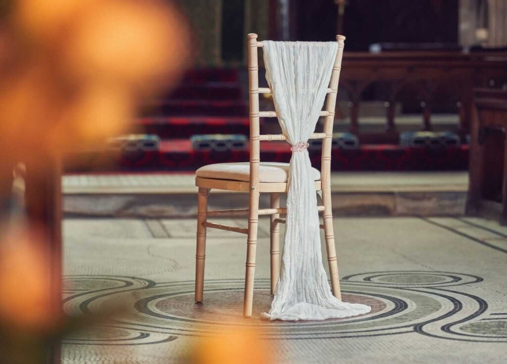 White chair drape for hire styled on an open-back chair