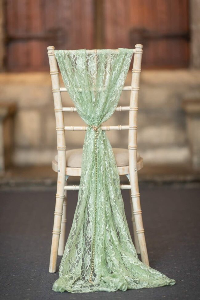 Sage drape styled as a lace vertical drop on a chiavari chair