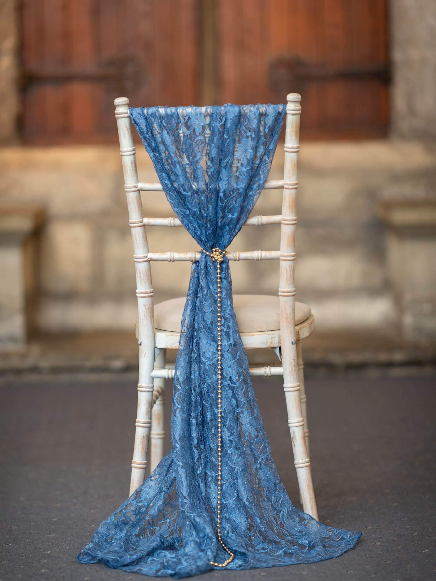 Navy lace chair drape for hire styled on a Chiavari chair