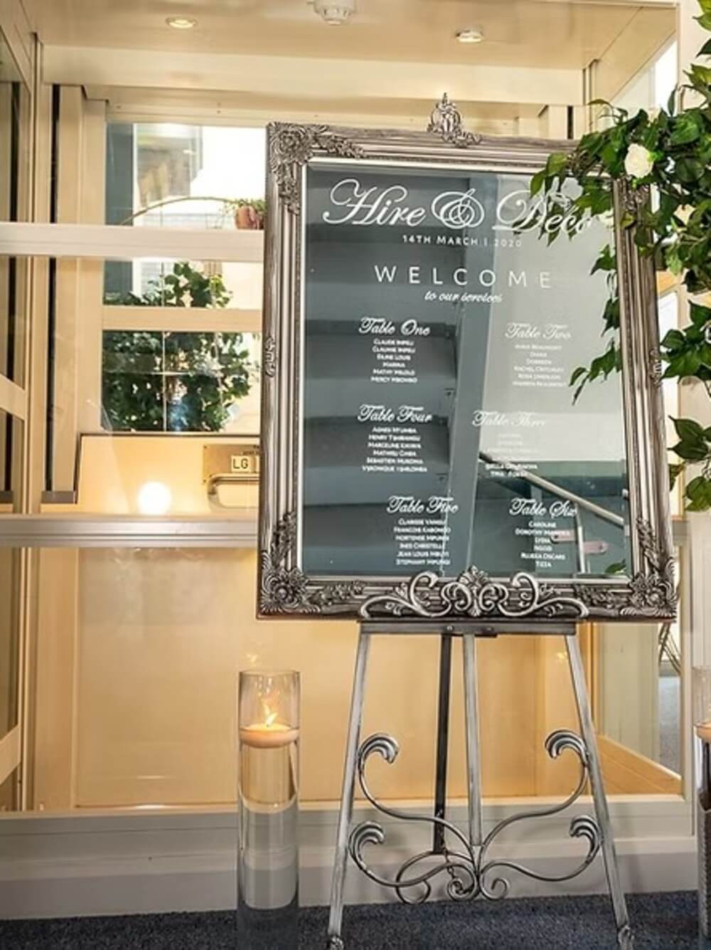 Mirror sign display on a silver antique French easel at a venue entrance