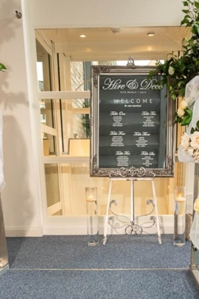 Mirror rental wedding sign display paired with a silver easel