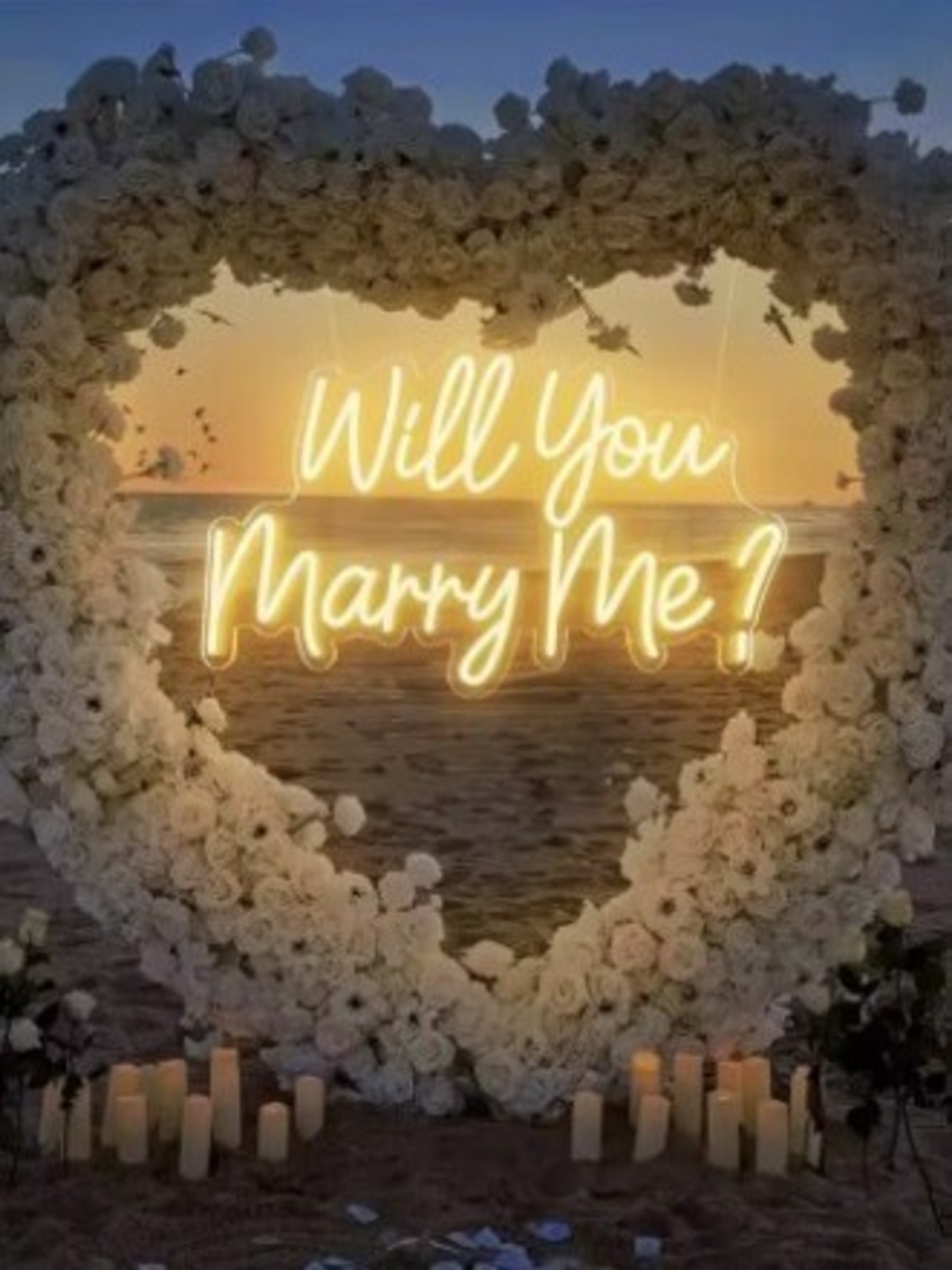 Will You Marry Me? neon sign on a heart floral backdrop