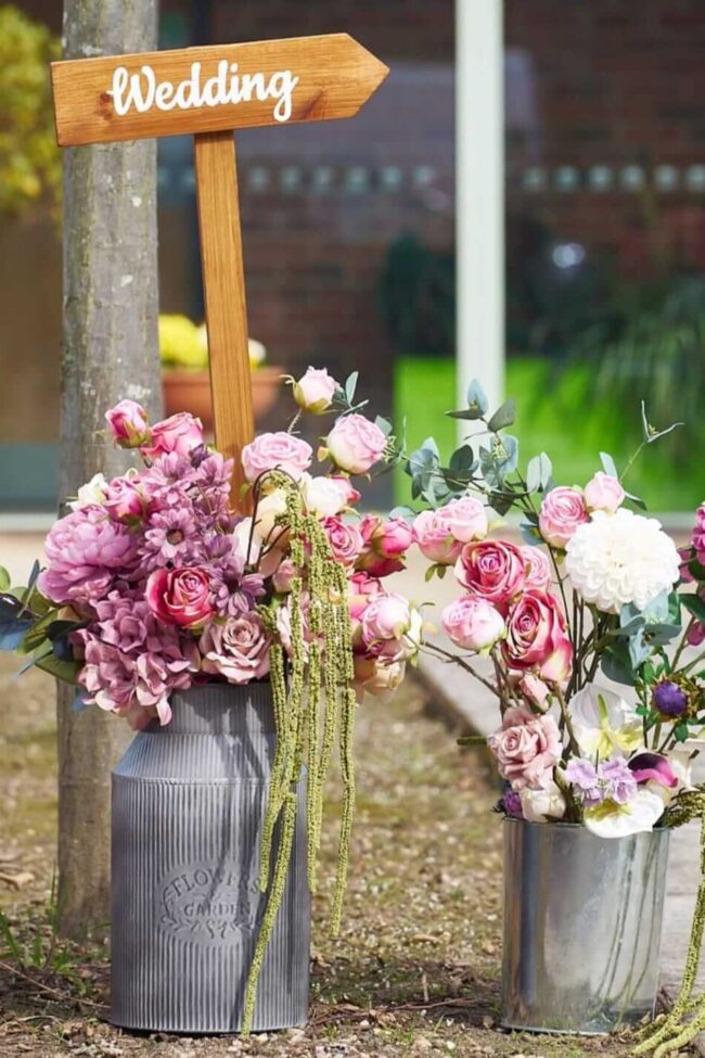 wooden wedding directional sign with floral styling