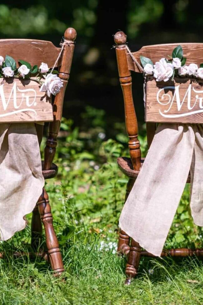 Mr & Mrs Chair Signs on rustic wedding chairs