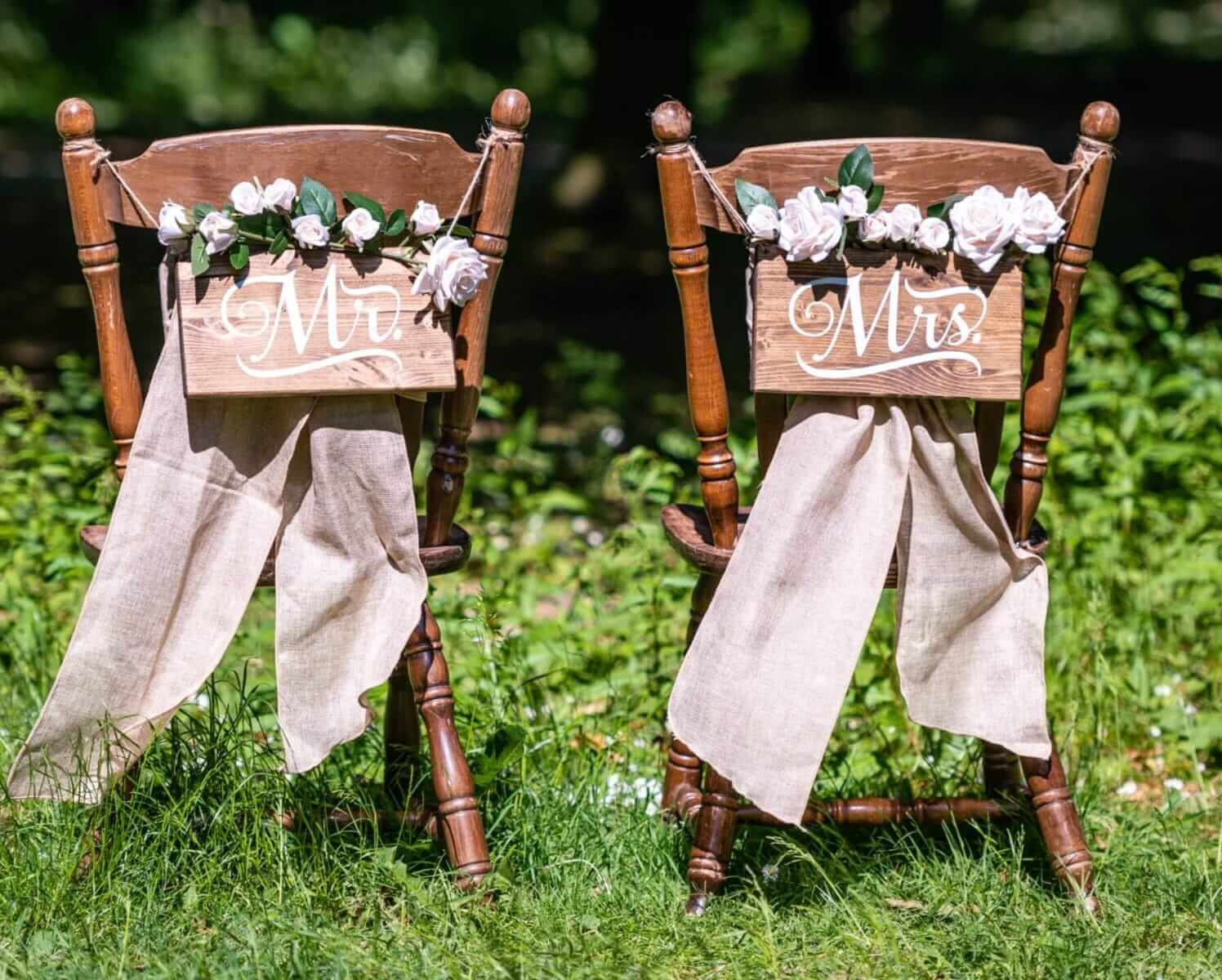 Mr & Mrs Chair Signs on rustic wedding chairs