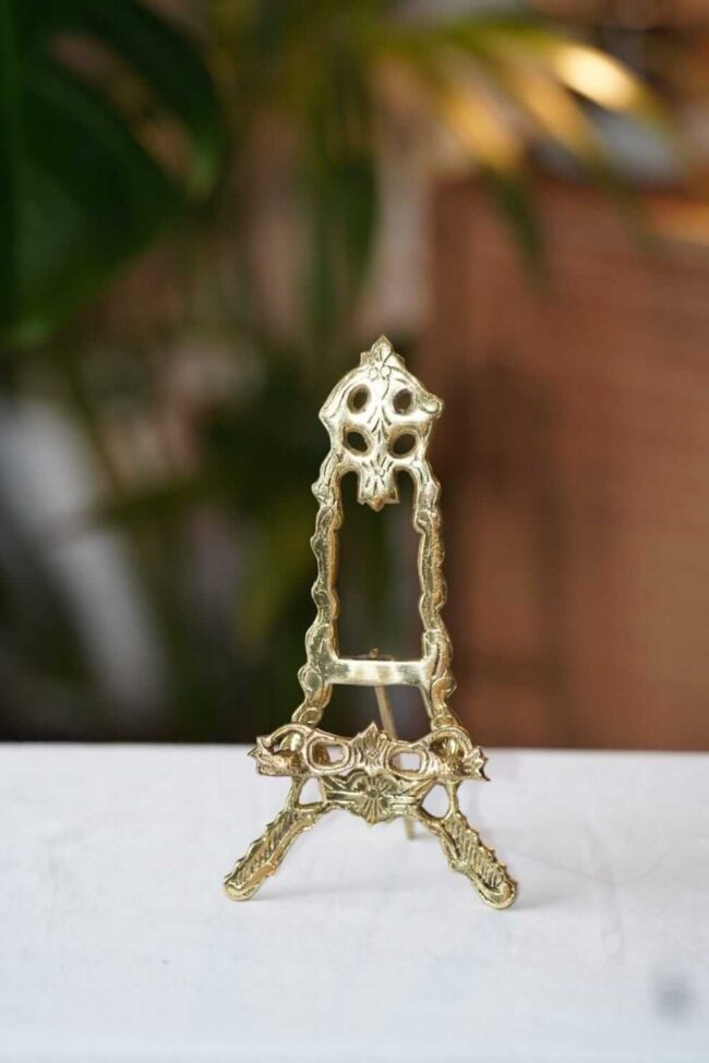 Brass easel stand on a table for hire