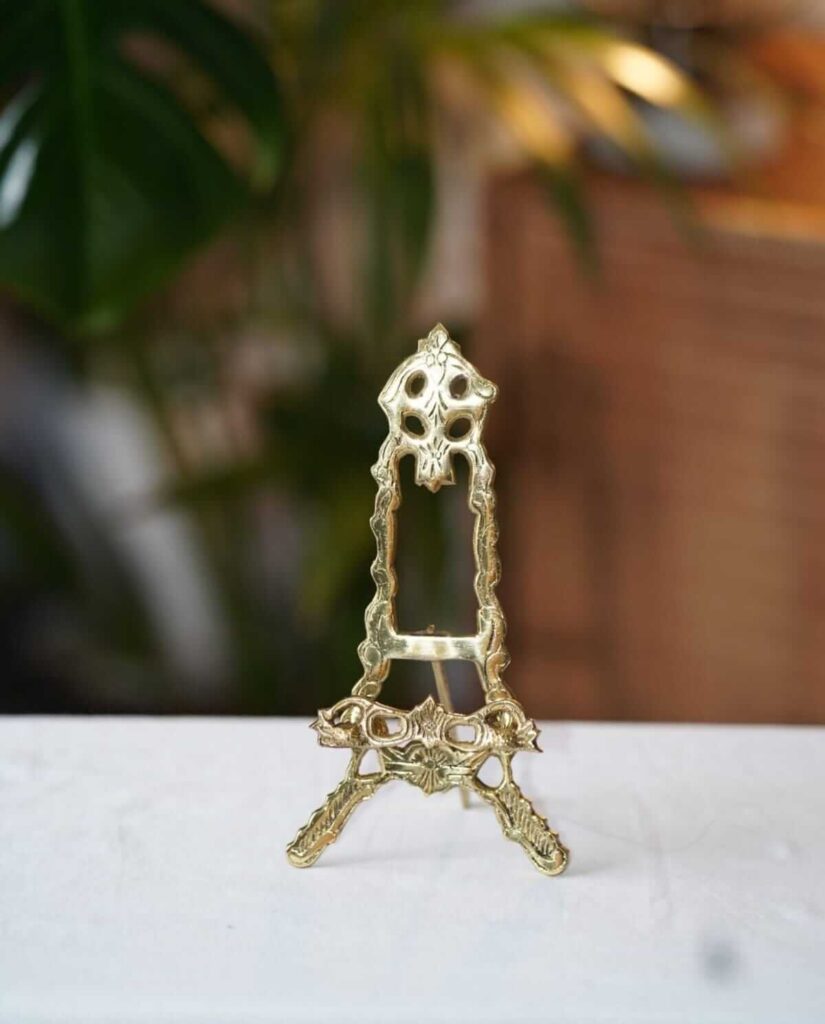 Brass easel stand on a table for hire