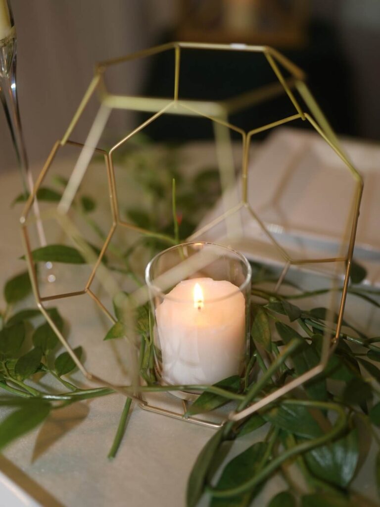 Geometric lantern with gold frame and glass candle holder for warm candlelight