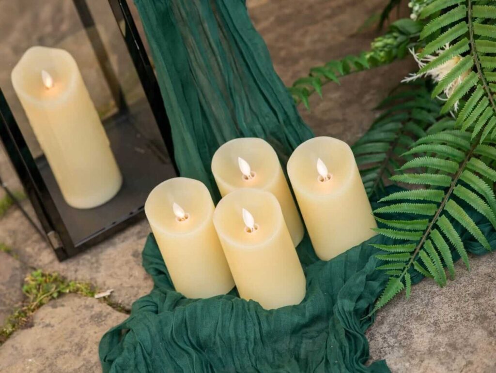 LED pillar candles grouped with a lantern for aisle glow
