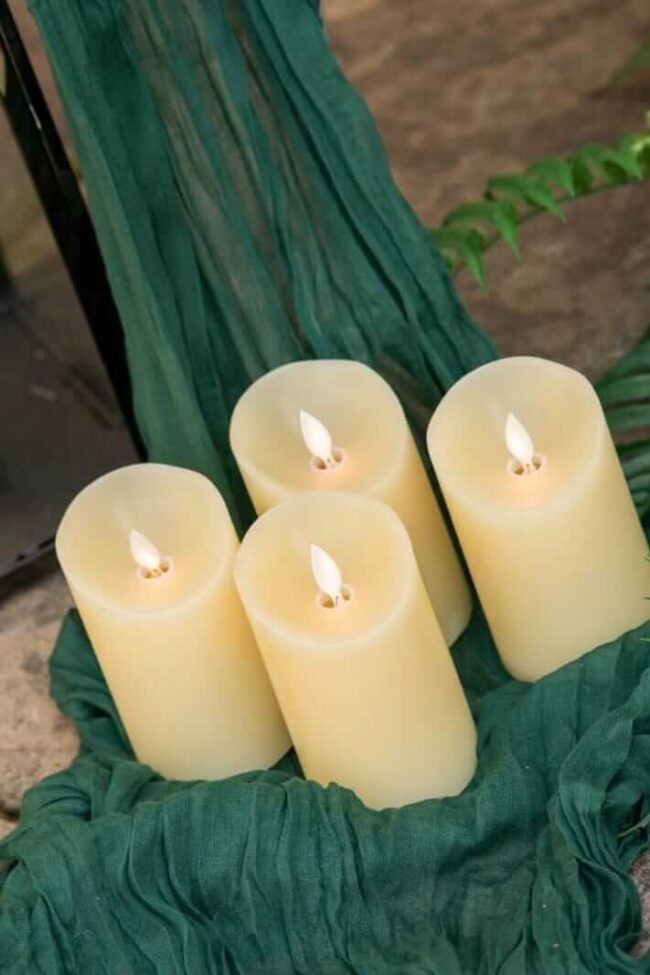 LED pillar candles grouped with a lantern for aisle glow