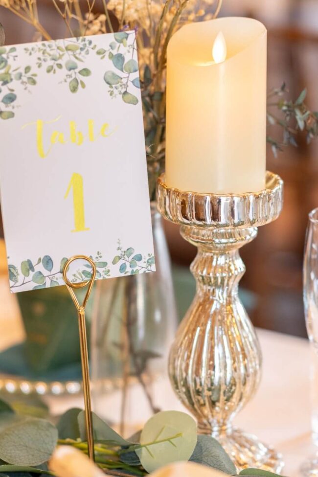 Flameless pillar candle on silver pedestal for warm table glow