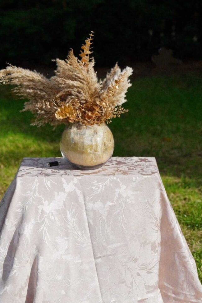 Damask tablecloths in champagne on a rectangular display table