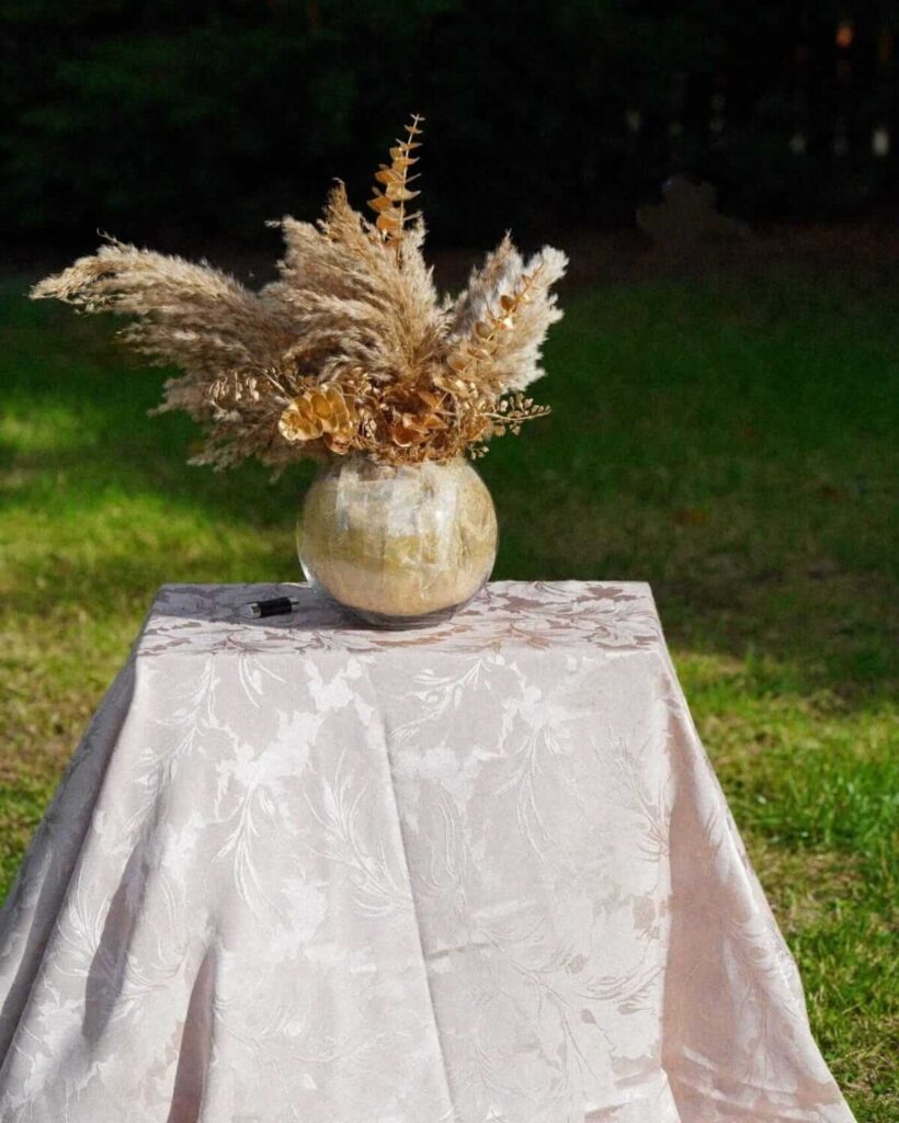 Damask tablecloths in champagne on a rectangular display table