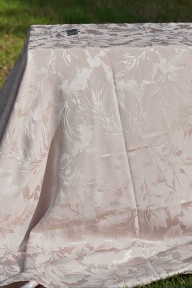 Damask tablecloths in champagne close-up on a rectangular table