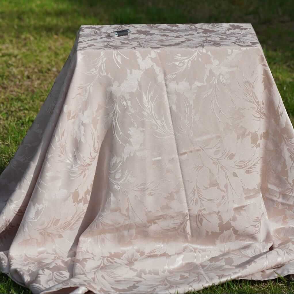 Damask tablecloths in champagne close-up on a rectangular table