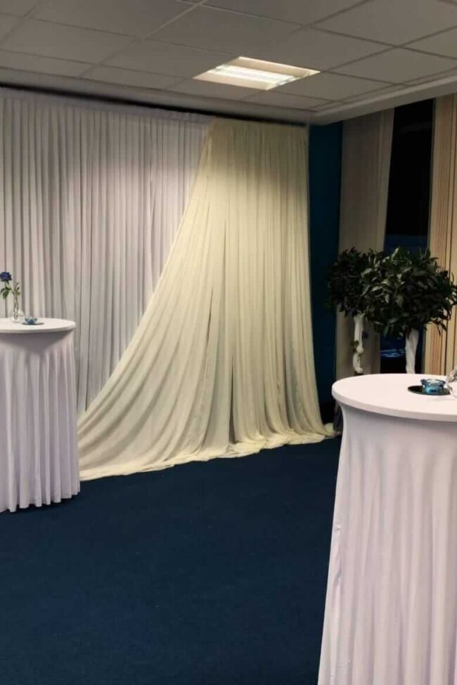 Poseur table cloth in white across multiple cocktail tables