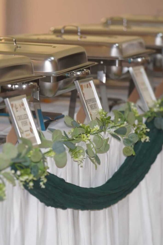 Skirt tablecloths on banqueting buffet table for hire