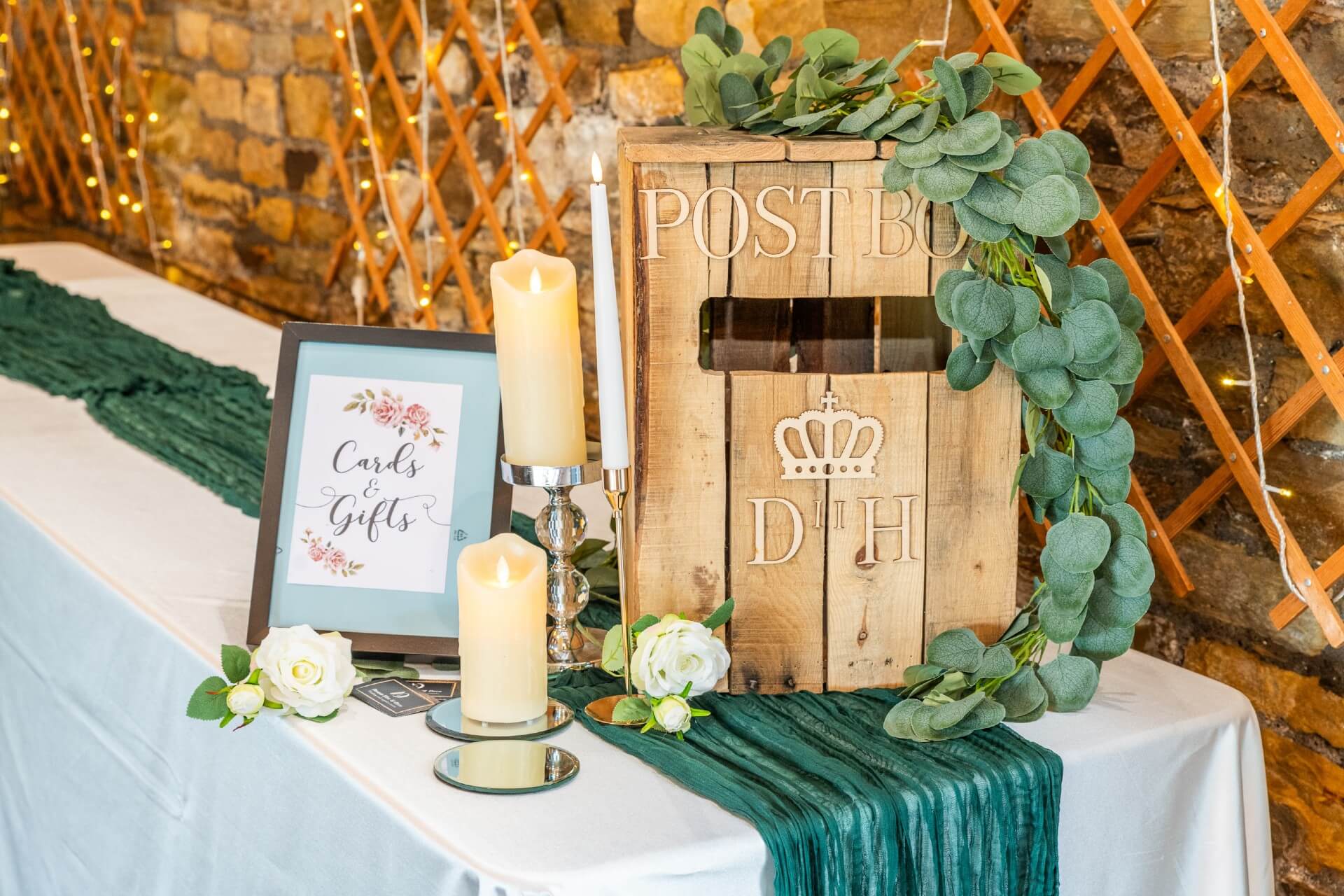 Green cheesecloth runner styled on a gift table with box décor