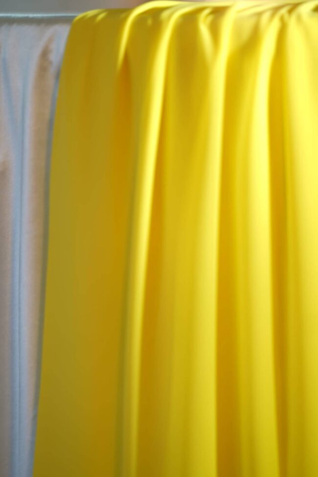yellow table runner in 5m chiffon draped over a dressed table edge