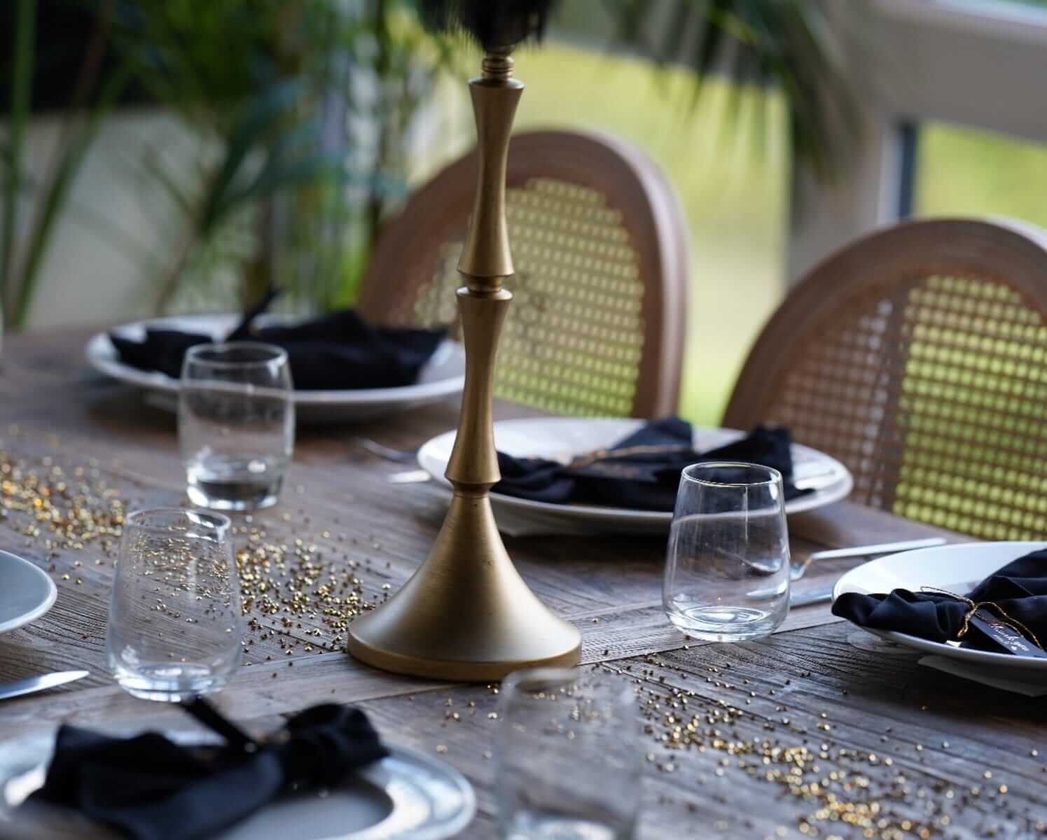 Napkins black styled on a neutral table with plates and glassware