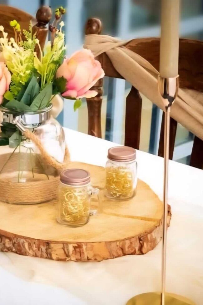 vase with jute rope on log timber slices with floral styling