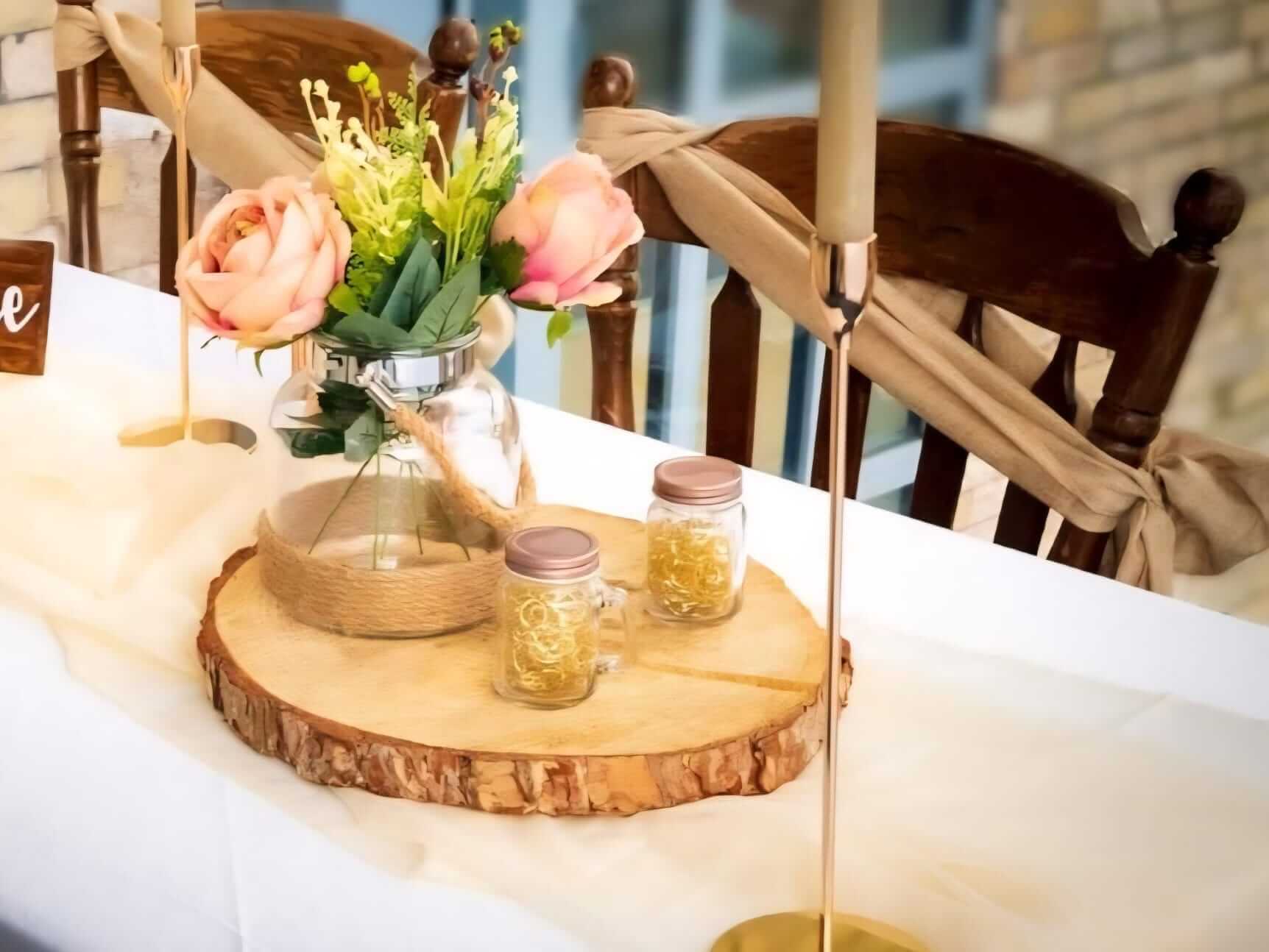 vase with jute rope on log timber slices with floral styling