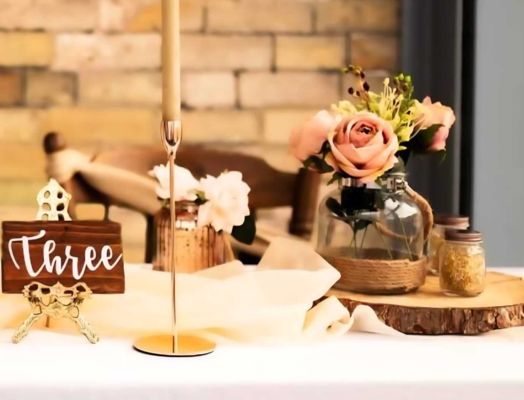 glass vase with jute rope styled on a log slice base