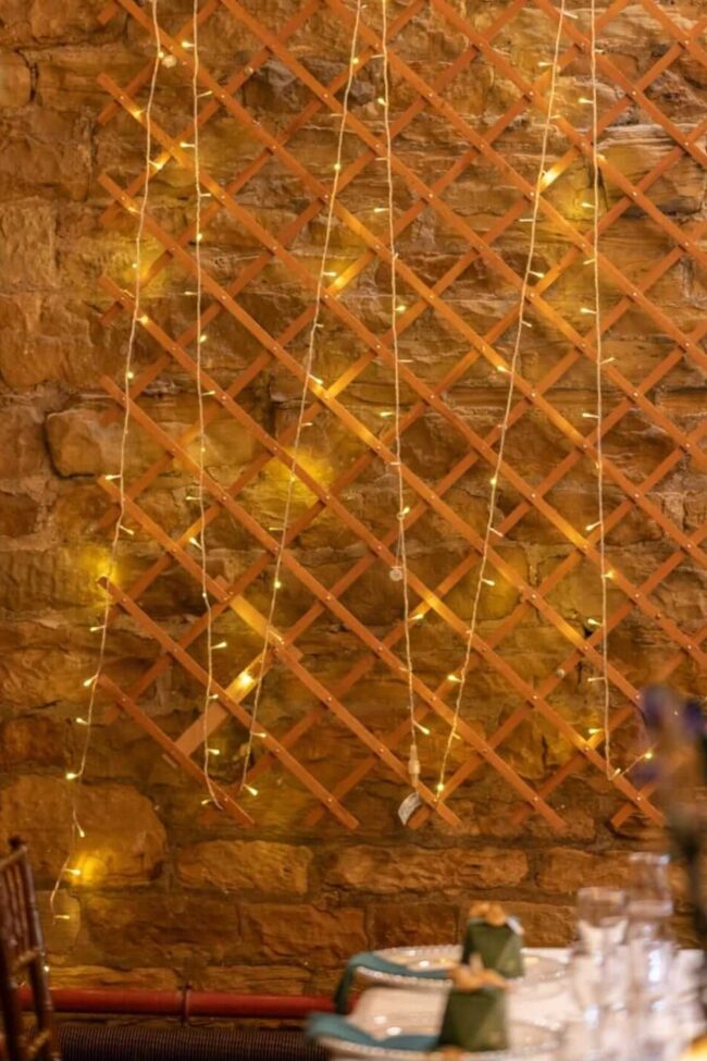 Wedding fairy lights hire with floral backdrop styling