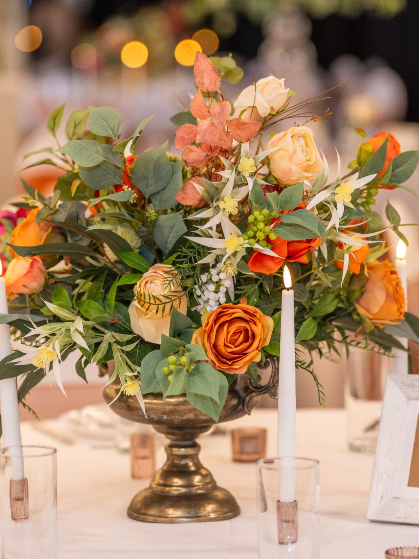 Short artificial flower centrepiece styled for wedding and event tables