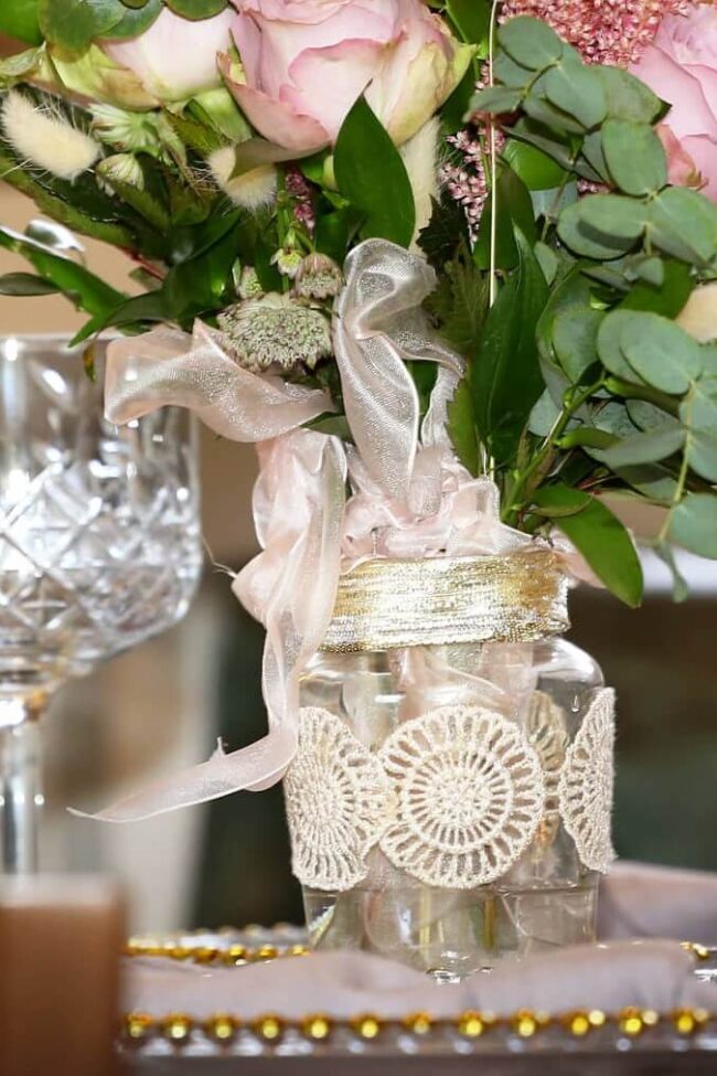 Small fresh flower arrangements in a decorative vase for table decor