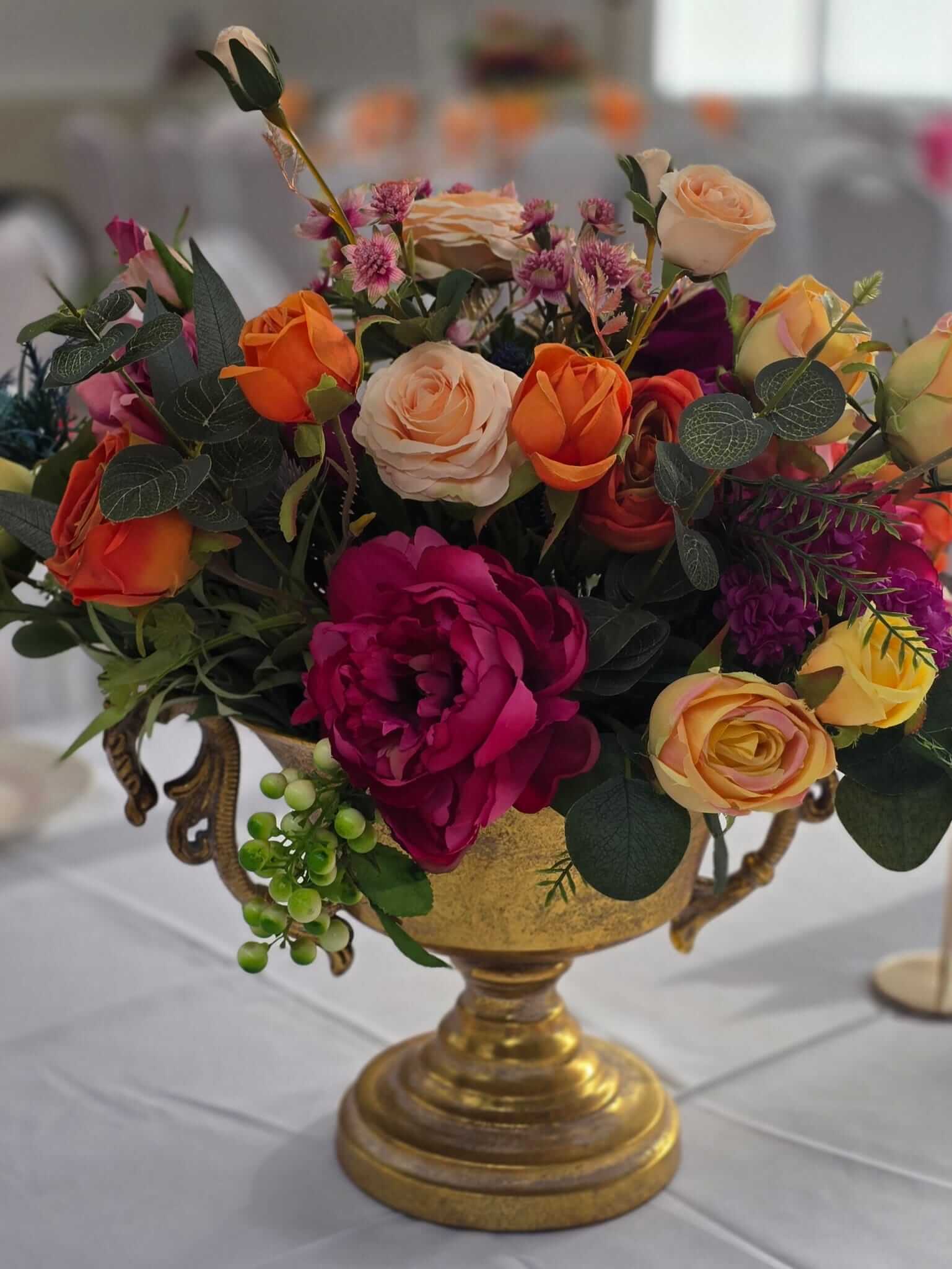 Gold metal flower bowl styled with a short floral display for event tables