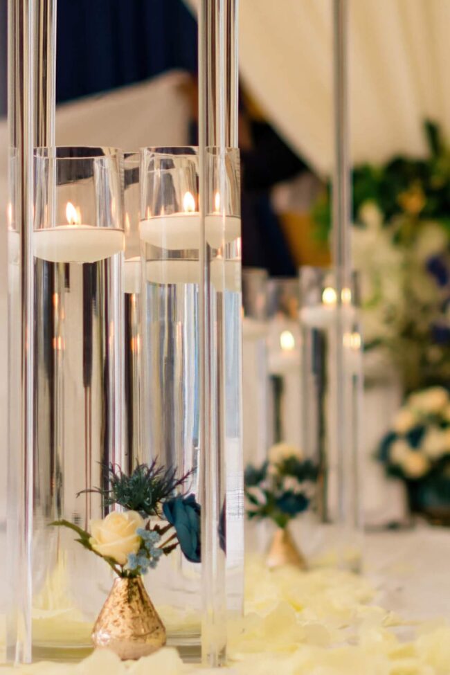Cylinder candle vase used in an elegant glass table display for weddings