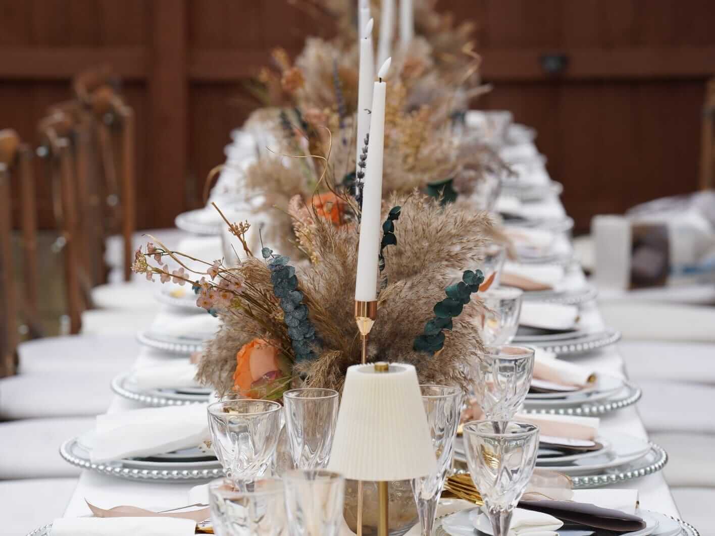 Clear fish bowl vase styled within a wedding table display