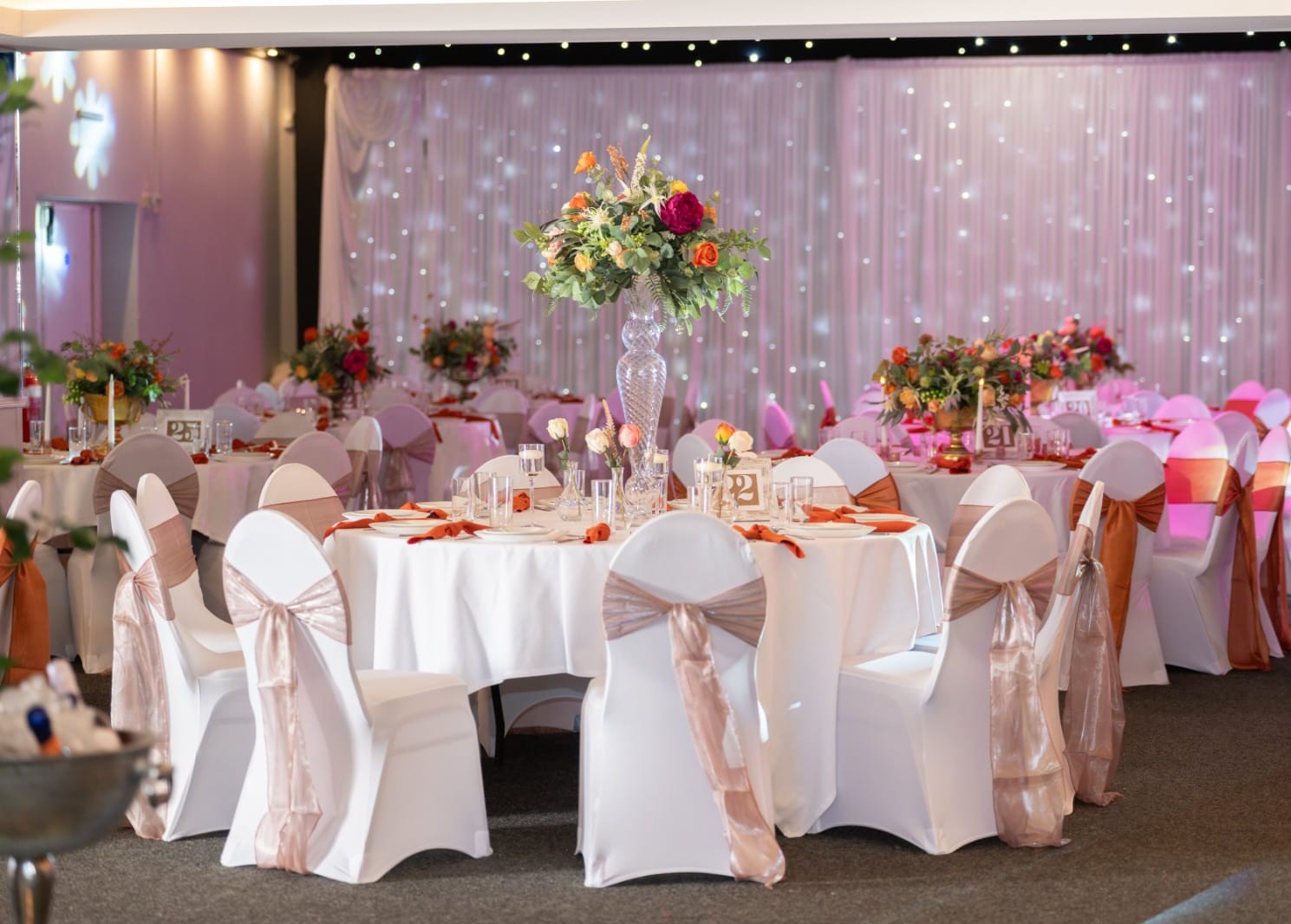 White chair covers with sashes at a styled event venue