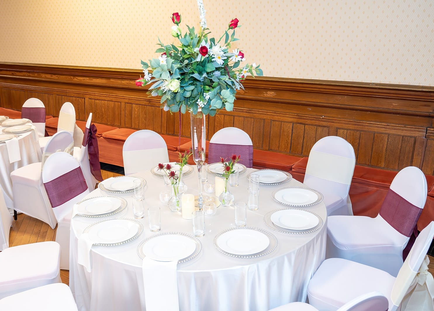White chair covers around a styled event table